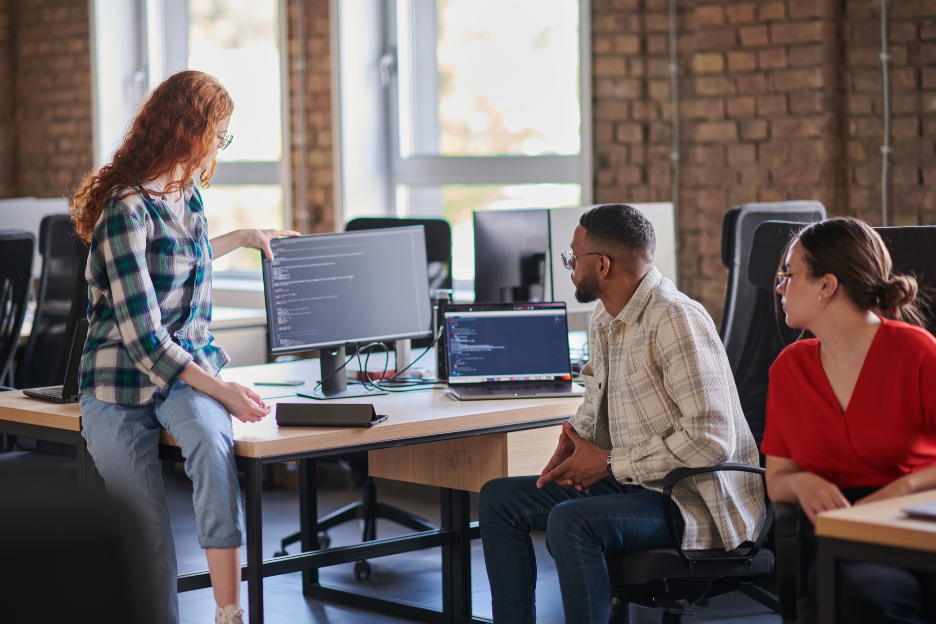 A diverse group of young business individuals congregates in a modern startup coworking center, embodying collaborative innovation and a dynamic atmosphere.